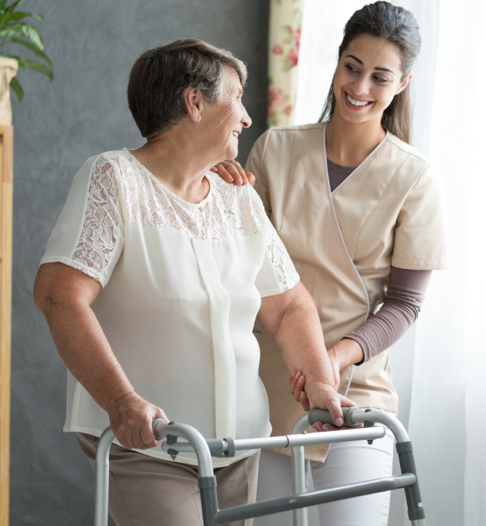 Nurse Helping Senior Citizen To Walk